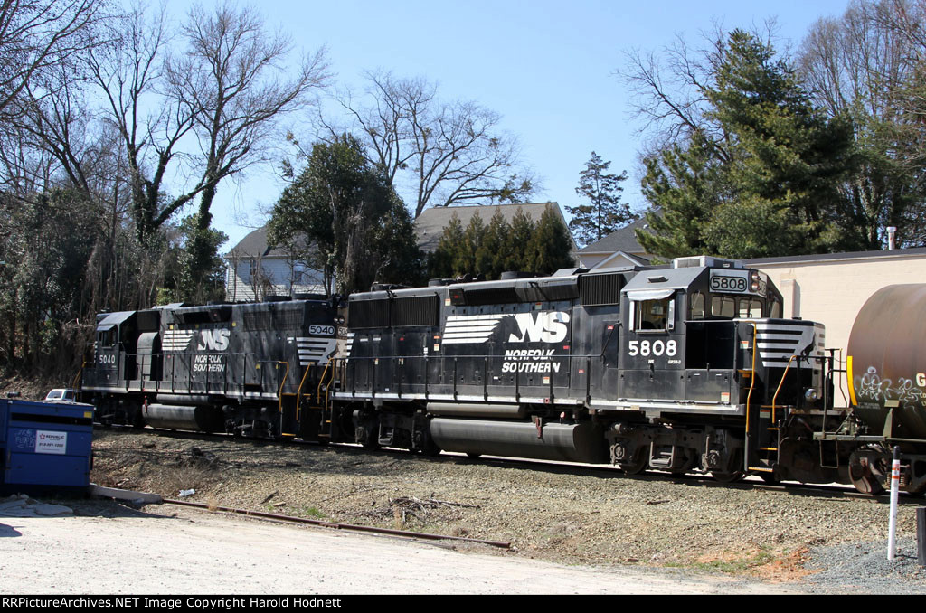 NS 5040 & 5808 are power for train E60 and are pushing a train into the yard